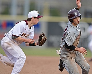 STRUTHERS, OHIO - MARCh 25, 2017: Evan Kanus #17 of Boardman regains his balance after avoiding a tag from third basemen Jared Bajerski #18 of South Range in the fifth inning of Saturday evenings game. South Range won 4-3 in 10 innings. DAVID DERMER | THE VINDICATOR