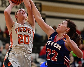 WARREN, OHIO - MARCH 28, 2017: Sara Price #20 of Howland goes to the basket while being pressured by Natalie Lynn #22 of Fitch during the second half of the Frank Bubba Girls All Star Game, Tuesday night at Warren Harding High School. DAVID DERMER | THE VINDICATOR