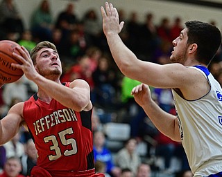 WARREN, OHIO - MARCH 28, 2017: Sam Hitchcock #35 of Jefferson looks to the basket while being pressured by Zach Dawson #30 of Maplewood during the first half of the Frank Bubba Boys All Star Game, Tuesday night at Warren Harding High School. DAVID DERMER | THE VINDICATOR