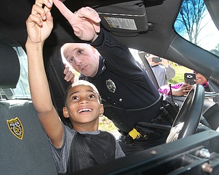 William D. Lewis The Vindicator   YPD Ptlm Steven Gibson in Homestead park where he befriended some local kids and became a star on facebook. He is shown here in his cruiser with  Colde Adams, 8.