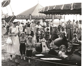 Kids enjoy the rides at the 1954 Canfield Fair.