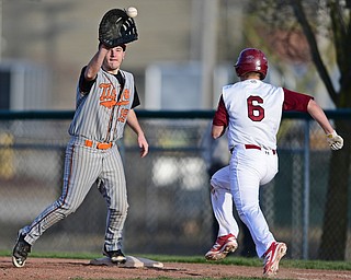 STRUTHERS, OHIO - MARCH 29, 2017: First basemen Nick Conklin #19 of Howland looks the ball into his glove to force out base runner Jake Fonderlin #6 of Mooney in the fourth inning of Wednesday nights game at Cene Park. DAVID DERMER | THE VINDICATOR
