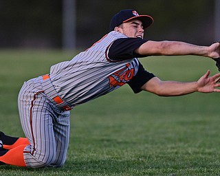 STRUTHERS, OHIO - MARCH 29, 2017: Left fielder Jackson Deemer #18 of Howland dives to catch the ball in the fifth inning of Wednesday nights game at Cene Park. DAVID DERMER | THE VINDICATOR