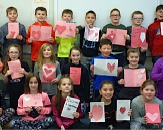 Neighbors | Submitted.Dobbins third-grade students in Marsha Walkama and Stephanie Davis' class held up Valentine's Day cards they made for the residents at Sunrise Assisted Living in Poland.