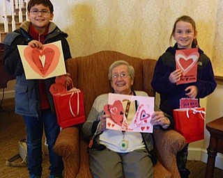 Neighbors | Submitted.Dobbins students Tim Spellig and Elliana Thompson gave Kitty Sekula her Valentine's Day card when they visited Sunrise Assisted Living.