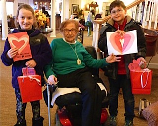 Neighbors | Submitted.Dobbins students Tim Spellig and Elliana Thompson gave Hilda Carano a Valentine's Day card when they visited the residents at Sunrise Assisted Living.