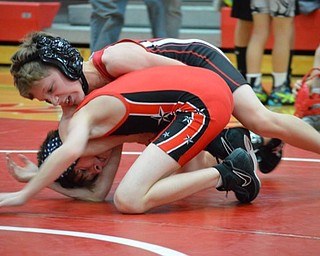 Neighbors | Submitted.Ryan Wissmar (top) of Canfield works to turn his opponent from Wellsville.