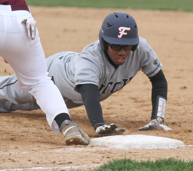 William D Lewis The Vindicator  Fitch's Malik Caige(19) gets back to 1rst ahead of the throw during a pickoff attempt. by Boardman 1rst baseman Evan Knaus(17) during 3-3--17 game in Boardman.
