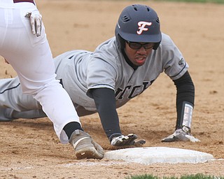 William D Lewis The Vindicator  Fitch's Malik Caige(19) gets back to 1rst ahead of the throw during a pickoff attempt. by Boardman 1rst baseman Evan Knaus(17) during 3-3--17 game in Boardman.