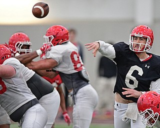 YOUNGSTOWN, OHIO - MARCH 31, 2017: Quarterback Hunter Wells #6, black, throws a pass from the pocket during practice Friday afternoon at the Watts training facility. DAVID DERMER | THE VINDICATOR