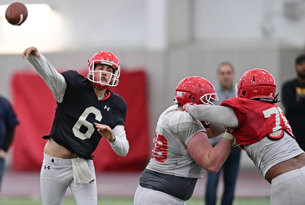 YOUNGSTOWN, OHIO - MARCH 31, 2017: Quarterback Hunter Wells #6, black, throws a pass behind the block of offensive linemen Connor Sharp #68, white, on defensive linemen Lamont Ragland #76 red, during practice Friday afternoon at the Watts training facility. DAVID DERMER | THE VINDICATOR