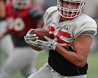 YOUNGSTOWN, OHIO - MARCH 31, 2017: Tight end Simon Smith #85, white, turns upfield to run with the football after a reception during practice Friday afternoon at the Watts training facility. DAVID DERMER | THE VINDICATOR