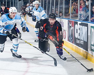 Scott R. Galvin | The Vindicator.Youngstown Phantoms forward Sam Craggs (17) skates the puck away form Lincoln Stars defenseman Luke Jaycox (6) during the first period  at the Covelli Centre on April 1, 2017..