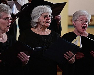 YOUNGSTOWN, OHIO - APRIL 2, 2017: (LtoR) Renee DiGia of New Castle, Sandy Megley of Youngstown and Sister Joanne Gardner of Girard, members of the Mahoning Valley Chorale Lenten choir, performance of "Within the Shadow of the Cross", at St. Angela Merici Parish, Sunday afternoon. DAVID DERMER | THE VINDICATOR