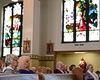 YOUNGSTOWN, OHIO - APRIL 2, 2017: Natalie Majoros of Boardman, left, and Mary Costello of Boardman, right, listen to a performance by the Mahoning Valley Chorale Lenten Concert at St. Angela Merici Parish, Sunday afternoon. DAVID DERMER | THE VINDICATOR