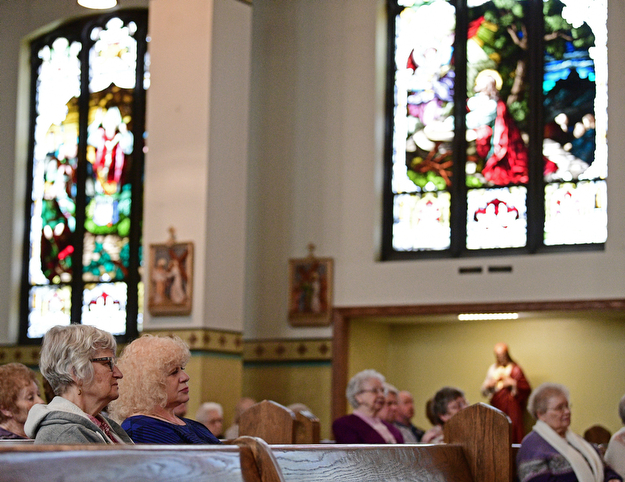 YOUNGSTOWN, OHIO - APRIL 2, 2017: Natalie Majoros of Boardman, left, and Mary Costello of Boardman, right, listen to a performance by the Mahoning Valley Chorale Lenten Concert at St. Angela Merici Parish, Sunday afternoon. DAVID DERMER | THE VINDICATOR