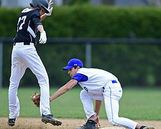 POLAND, OHIO - APRIL 3, 2017: Short stop Braeden O'Shaughnessy #4 of Poland picks off base runner B.J. Arnold #27 of Harding in the second inning of Monday nights game at Poland High School. DAVID DERMER | THE VINDICATOR