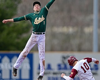 STRUTHERS, OHIO - APRIL 4, 2017: Short stop Bobby Cavalier #7 of Ursuline flies through the air to catch the high throw from the catcher while Dom Pecchia #10 of Mooney steals second base in the third inning of Tuesday nights game at Cene Park. Mooney won 10-6. DAVID DERMER | THE VINDICATOR