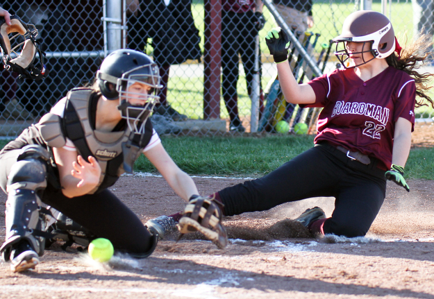 William D. Lewis the vindicator Boardman's Ashley Saxton (22) slides into home to score during a 4-5-17 game with Howland at Boardman. Howland Catcher Kamryn Buckley(20) loses control of the ball.