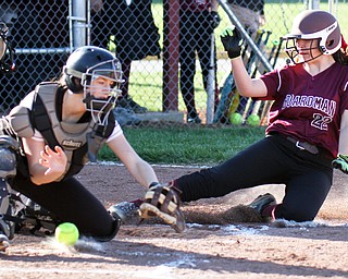 William D. Lewis the vindicator Boardman's Ashley Saxton (22) slides into home to score during a 4-5-17 game with Howland at Boardman. Howland Catcher Kamryn Buckley(20) loses control of the ball.
