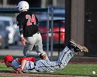STRUTHERS, OHIO - MARCH 27, 2017: Relief pitcher Anthony Monaco #6 of Struthers lays on the ground after colliding with Shawn Leasure #24 of Girard while attempting to play a ball near the foul line in the fourth inning of Monday nights game at Cene Park. DAVID DERMER | THE VINDICATOR