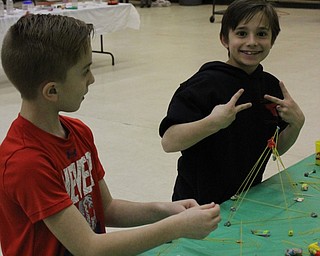 Neighbors | Abby Slanker.A Hilltop Elementary School first-grade student celebrated after building a noodle play dough structure at an engineering station during the school’s annual STEM Week on March 7.