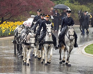 A horse drawn caisson carries former astronaut and Sen. John Glenn to his final resting place during the interment ceremony at Arlington National Cemetery on Thursday, April 6, 2017, in Arlington, Va. Glenn was the first American to orbit Earth on Feb. 20, 1962, in a five-hour flight aboard the Friendship 7 spacecraft. In 1998, he broke another record by returning to space at the age of 77 on the Space Shuttle Discovery. (Aubrey Gemignani/NASA via AP)