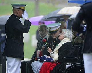 In this U.S. Army photo by Rachel Larue/Arlington National Cemetery, Marine Corps Commandant Gen. Robert B. Neller, left, salutes Annie Glenn, widow of John Glenn, following the American flag presentation during the graveside service for Glenn at Arlington National Cemetery in Arlington, Va., Thursday, April 6, 2017. Glenn, who died Dec. 8 at age 95, was laid to rest in a private burial attended by relatives and invited guests. His family scheduled the service for what would have been John and Annie Glenn's 74th wedding anniversary. (U.S. Army photo by Rachel Larue/Arlington National Cemetery via AP)