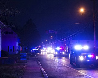The remains of astronaut and Sen. John Glenn accompanied by a police escort pass through the town of Camden, Del., Thursday, April 6, 2017, as they make their way to Arlington National Cemetery. Family and invited guests are gathering at the cemetery on Thursday to say their final goodbyes. Glenn, the first American to orbit Earth, died Dec. 8, 2016, at age 95. (Jason Minto/The Wilmington News-Journal via AP)