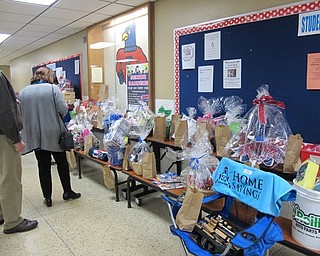 Neighbors | Alexis Bartolomucci.Guests at the Souper Supper on March 16 at Austintown Fitch High School put tickets in bags to get a chance to win a prize basket.