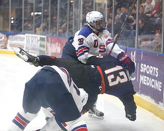 Phantoms forward Nicolas Werbik(13) is knocked over Team USA defensemen Spencer Stastney(47) by forward Jonathan Gruden(38) during the 1st period as the USA Hockey's National Team takes on the Youngstown Phantoms, Saturday, April 8, 2017 at the Covelli Centre. The Phantoms won 3-0...(Nikos Frazier | The Vindicator)..