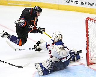 Phantoms forward Pierce Crawford(17) trips over Team USA goalie Anthony Yamnitsky(60) during the 2nd period as the USA Hockey's National Team takes on the Youngstown Phantoms, Saturday, April 8, 2017 at the Covelli Centre. The Phantoms won 3-0...(Nikos Frazier | The Vindicator)..