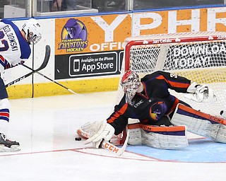 Phantoms goalie Ivan Kulbakov(31) picks up the puck after an attempted goal by Team USA forward Jake Goldowski(33) during the 3rd period as the USA Hockey's National Team takes on the Youngstown Phantoms, Saturday, April 8, 2017 at the Covelli Centre. The Phantoms won 3-0...(Nikos Frazier | The Vindicator)..