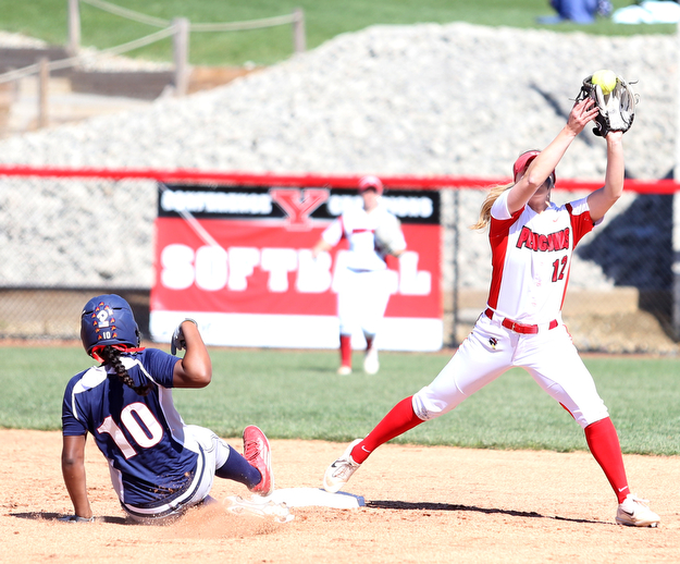 Youngstown State shortstop Tatum Christy(12) reaches up for the ball tagging out UIC infielder Tiana Mack-Miller(10) during the 3rd inning as the the UIC Flames  take on the Youngstown Penguins, Saturday, April 8, 2017 at the YSU Softball Field. ..(Nikos Frazier | The Vindicator)..