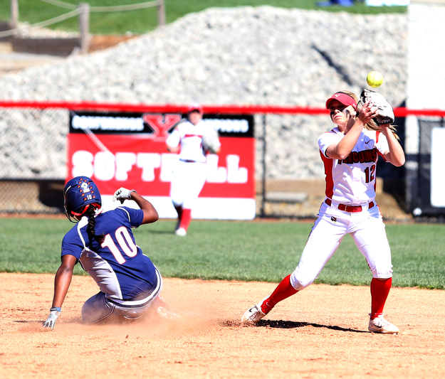 Youngstown State shortstop Tatum Christy(12) reaches up for the ball tagging out UIC infielder Tiana Mack-Miller(10) during the 3rd inning as the the UIC Flames  take on the Youngstown Penguins, Saturday, April 8, 2017 at the YSU Softball Field. ..(Nikos Frazier | The Vindicator)..
