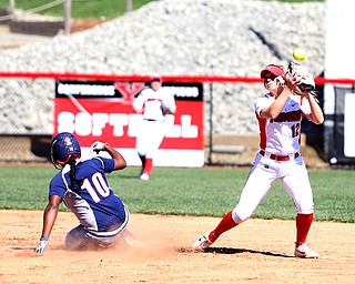 Youngstown State shortstop Tatum Christy(12) reaches up for the ball tagging out UIC infielder Tiana Mack-Miller(10) during the 3rd inning as the the UIC Flames  take on the Youngstown Penguins, Saturday, April 8, 2017 at the YSU Softball Field. ..(Nikos Frazier | The Vindicator)..