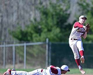 STRUTHERS, OHIO - APRIL 8, 2017: Cardinal Mooney's Bryce Richey (8) throws to first for the out after Chris Lewis dove unsuccessfully to play the ball in the sixth inning of Saturday afternoons game at Cene Park. St. Ed's won 4-1. DAVID DERMER | THE VINDICATOR
