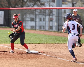 Youngstown State junior first baseman Kelly Thompson-Cappadocio(7) receives a pass to out UIC senior outfielder Savannah Soppet(3) during the 1st inning as the UIC Flames take on the Youngstown State Penguins, Sunday, April 9, 2017 at the YSU Softball Field. The Flames won 2-1...(Nikos Frazier | The Vindicator)..