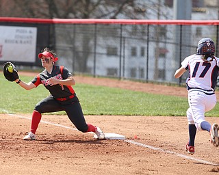 Youngstown State junior first baseman Kelly Thompson-Cappadocio(7) receives a pass to out UIC junior infielder Taylor Cairns(17) during the 2nd inning as the UIC Flames take on the Youngstown State Penguins, Sunday, April 9, 2017 at the YSU Softball Field. The Flames won 2-1...(Nikos Frazier | The Vindicator)..