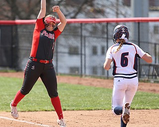 Youngstown State junior first baseman Kelly Thompson-Cappadocio(7) reaches high for the catch as UIC freshman infielder Kayla Wedl(6) runs towards first during the 3rd inning as the UIC Flames take on the Youngstown State Penguins, Sunday, April 9, 2017 at the YSU Softball Field. The Flames won 2-1...(Nikos Frazier | The Vindicator)..