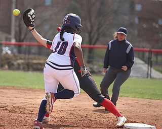 UIC junior infielder Tiana Mack-Miller(10) runs to first as Youngstown State junior first baseman Kelly Thompson-Cappadocio(7) opens up her mitt for the pass during the 3rd inning as the UIC Flames take on the Youngstown State Penguins, Sunday, April 9, 2017 at the YSU Softball Field. The Flames won 2-1...(Nikos Frazier | The Vindicator)..