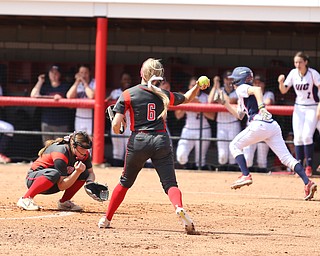 Youngstown State freshman pitcher Maddi Lusk(10) ducks as Youngstown State junior  Stevie Taylor(6) throws to first during the 4th inning as the UIC Flames take on the Youngstown State Penguins, Sunday, April 9, 2017 at the YSU Softball Field. The Flames won 2-1...(Nikos Frazier | The Vindicator)..