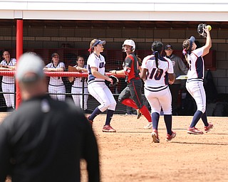 UIC freshman pitcher Allie Trudeau(7) misses the catch as Youngstown State freshman pitcher Maddi Lusk(10) watches while running towards first during the 4th inning as the UIC Flames take on the Youngstown State Penguins, Sunday, April 9, 2017 at the YSU Softball Field. The Flames won 2-1...(Nikos Frazier | The Vindicator)..