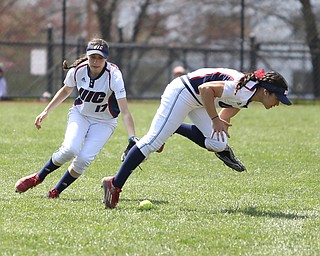 UIC sophomore outfielder Lexi Watts(1) dives for the ball as UIC junior infielder Taylor Cairns(17) watches during the 5th inning as the UIC Flames take on the Youngstown State Penguins, Sunday, April 9, 2017 at the YSU Softball Field. The Flames won 2-1...(Nikos Frazier | The Vindicator)..
