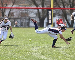 UIC sophomore outfielder Lexi Watts(1) dives and misses the ball as UIC junior infielder Taylor Cairns(17) watches during the 5th inning as the UIC Flames take on the Youngstown State Penguins, Sunday, April 9, 2017 at the YSU Softball Field. The Flames won 2-1...(Nikos Frazier | The Vindicator)..