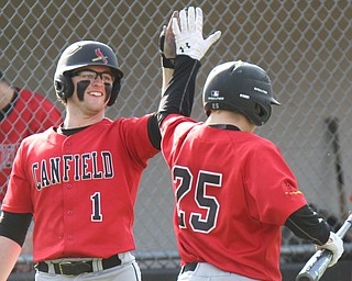 William D. Lewis The Vindicator  Canfield's Angelo Petracci(25) gets hi 5 from Anthony Longo after scoring during 4-10-17 game with WGH at Canfield.