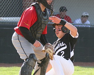 William D. Lewis The Vindicator  Canfield catcher Angelo Petracci(25) waits for the throw WGH's Antonio walker is safe at home during 4-10-17 game.