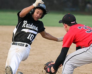 William D. Lewis The Vindicator  Canfield's  3rd baseman Jimmy fitzgerald(32)tags WGH Devin chambers(10) during 7th inning of4-10-17 game at Canfield.