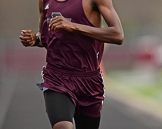BOARDMAN, OHIO - APRIL 11, 2017: Chris Butler of Boardman crosses the finish line after winning his heat of the boys mile run, Tuesday afternoon at Spartan Stadium. DAVID DERMER | THE VINDICATOR