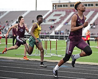 BOARDMAN, OHIO - APRIL 11, 2017: Jajuan Forte of Boardman sprints to the finish line ahead of Guy-Michael Kaho of Ursuline and Ethan Himes of Boardman during their heat of the boys 100 meter dash, Tuesday afternoon at Spartan Stadium. DAVID DERMER | THE VINDICATOR